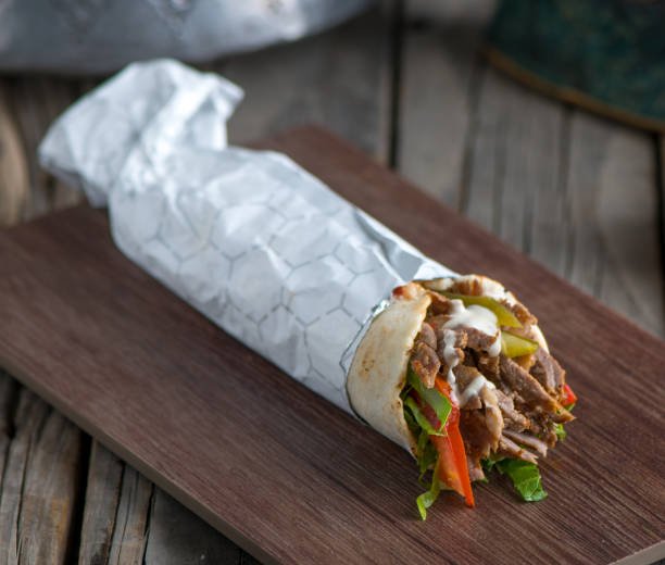 shawarma it is very famous dish of dubai, and has a meat in it and some type of salad too.